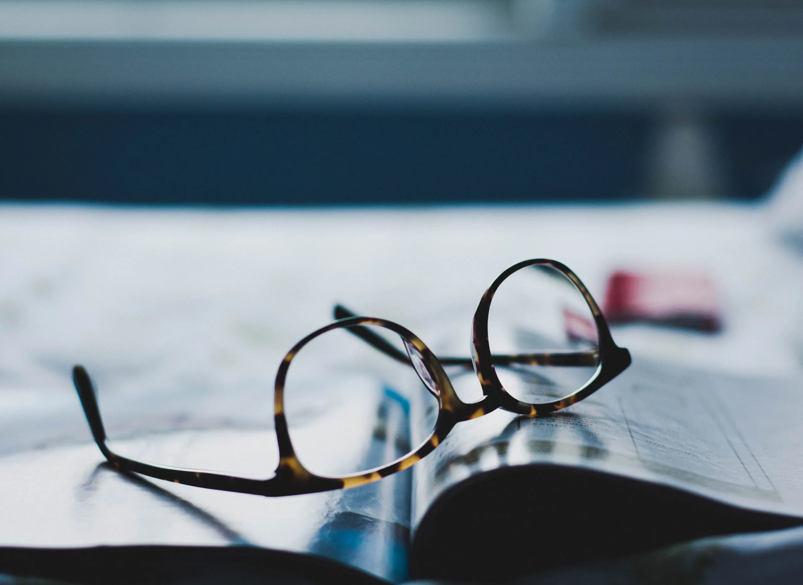 Reading glasses on open book